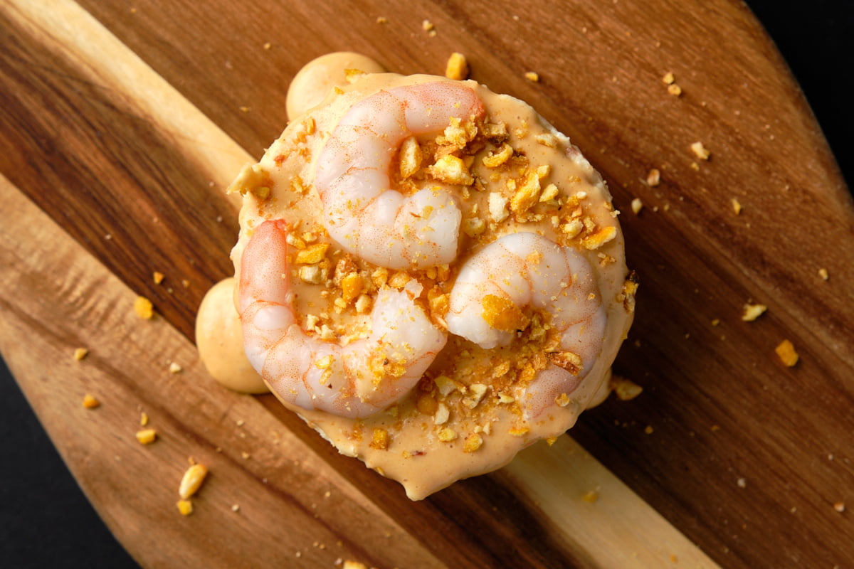 Ensaladilla rusa con gambas sobre tabla de madera